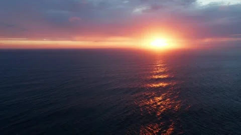 Drone flies over the waves during sunset with reflection on water. Beautifu.. Stock Footage 253269993