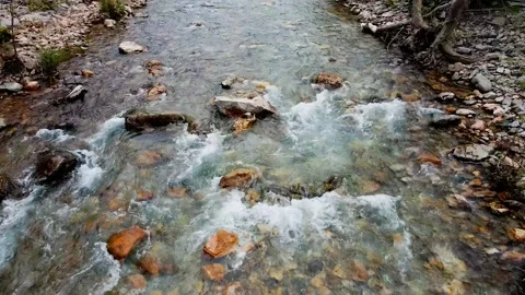 The drone flies over a wide mountain river 4k Stock Footage 213985308
