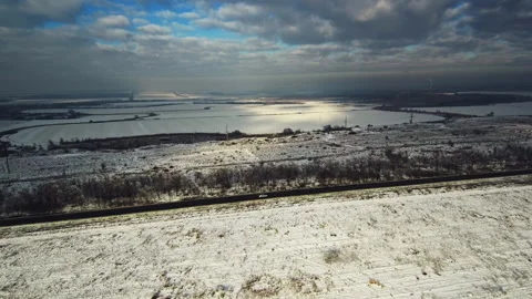 Drone flies over a winter snow-covered field Stock Footage 102808673