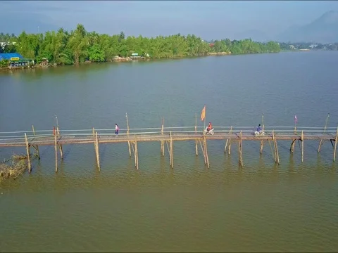 Drone Flies over Wooden Bridge People Ride Motorbikes Stock Footage