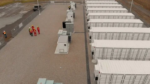 Drone flies over workers and battery containers Stock Footage 129784184