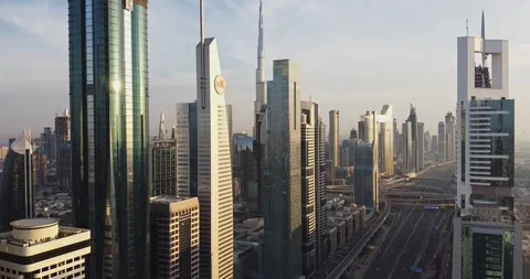 A drone flies over a young man standing on a helipad on the roof of a skyscraper Stock Footage 256643113