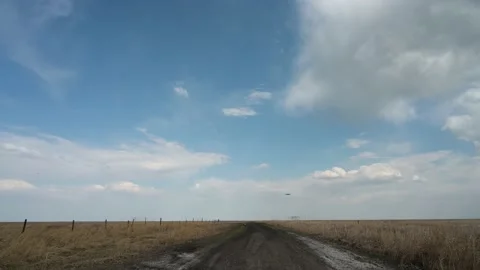 Drone flies past camera then rises into a blue sky filled with white clouds Stock Footage 155076917