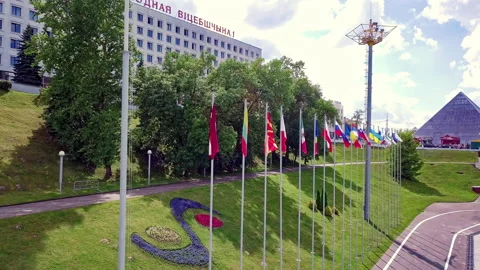 Drone flies past over a large number of country flags fluttering in the wind in Stock Footage 136733080