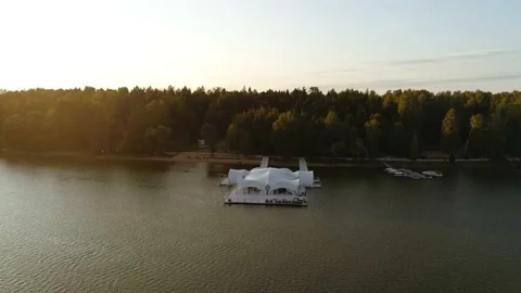 The drone flies up to the pier on which there is a large white marquee in which Stock Footage 169583783