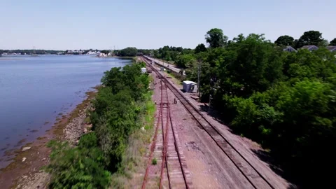 A drone flies quickly along empty passenger train tracks in Salem Stock Footage 340045075