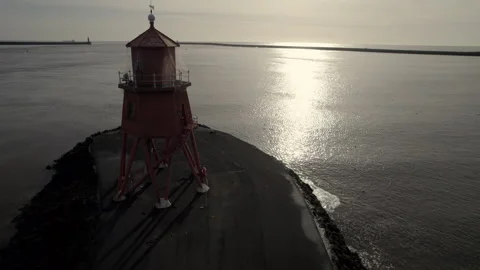 Drone flies quickly towards the Herd Groyne Lighthouse Stock Footage 281249964