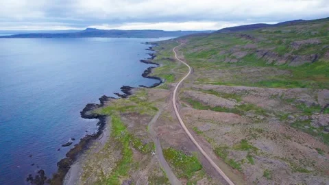 Drone Flies Remote Road From High to Low in West Fjords Iceland Coast Stock Footage 258489579