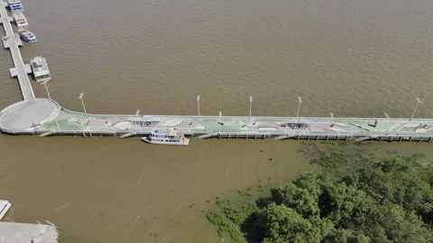 Drone flies to the right facing Saint Ines Pier in the Amazon River at high tide Stock Footage 290782664