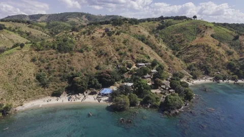 Drone flies to the right facing two beaches separated by rocks and trees Stock Footage 340776104
