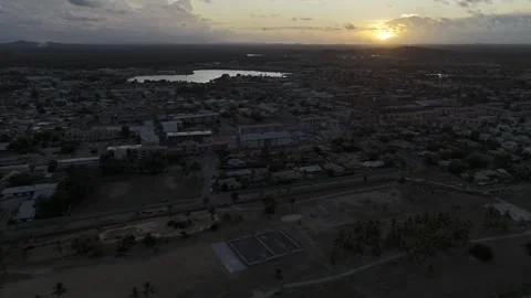 Drone flies to the right over Grand Parc de la Cocoteraie at sunset in Kourou 스톡 동영상 289132279