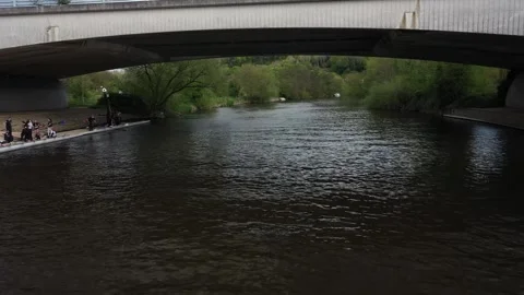 Drone flies at river level, passes under the wide arch of the A404(M) Stock Footage 308418892