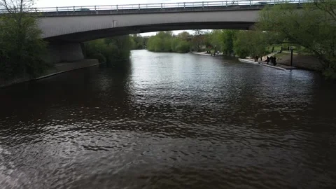 Drone flies at river level, passes under the wide arch of the A404(M) motorway b Stock Footage 308419009