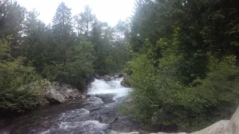 Drone flies up river over waterfall Stock Footage 115727602