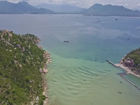 Drone Flies from Rocky Coast of Peninsula Tip to Azure Ocean Stock Footage