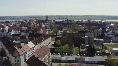 The drone flies sideways over the roofs of the town of Wittenberge in Stock Footage 163123607