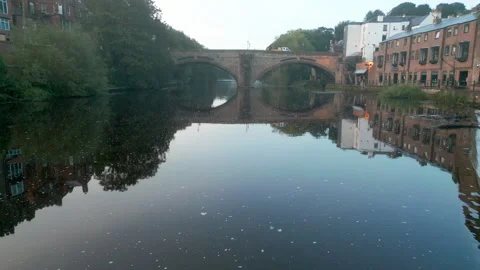 Drone flies sideways  over weir on the River Wear in Durham. Stock Footage 277578394