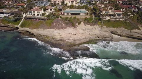 Drone flies sideways showing oceanfront San Diego mansions with private beaches Stock Footage 97164176