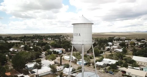 Drone flies slow arc around Marfa water tower Stock Footage 101039015