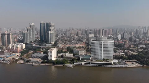 The drone flies slowly along the river in Guangzhou. Stock Footage 118242579