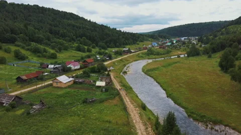 Drone flies slowly along small river flowing from the Sarva spring lake. Stock Footage 137649872