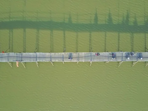 Drone Flies Slowly over Long Wooden Bridge with Motorbikes Stock Footage