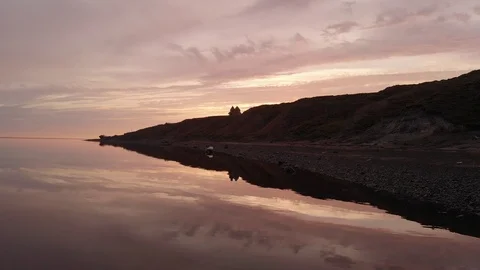 Drone flies slowly over the river during sunset. Stockbeeldmateriaal 98587656