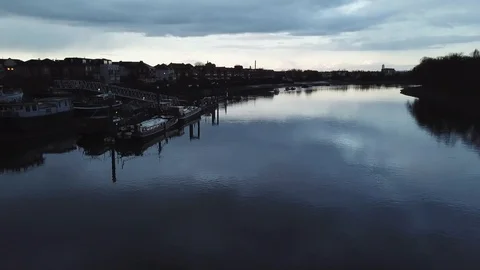 Drone flies slowly past river boats docked at a local marina in London, UK. 스톡 동영상 87848465