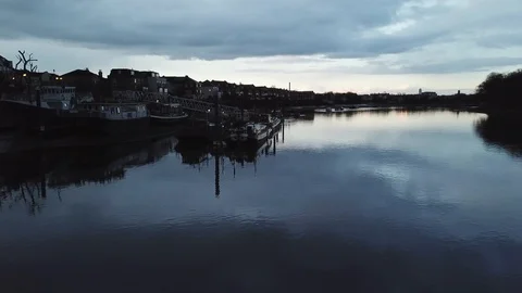 Drone flies slowly past river boats docked at a local marina in London, UK. 動画素材 87848503