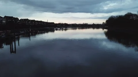 Drone flies slowly past river boats docked at a local marina in London, UK. Stock-Footage 87848827