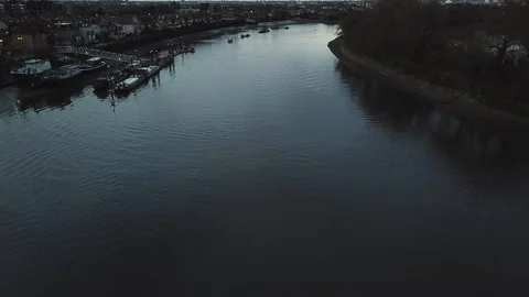 Drone flies slowly past river boats docked at a local marina in London, UK. Stock-Footage 87849557