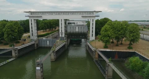 Drone flies to Sluice Gate Opening for Inland Tanker Vessel Under Blue Summer Stock Footage 342346947