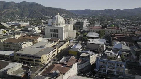 Drone flies south over the back of the metropolitan cathedral and library Stock Footage 306081747