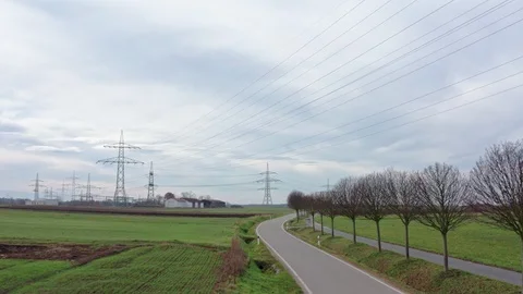 Drone flies straight ahead besides road with power lines in background, 4k Stock Footage 120646740