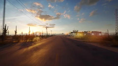 A drone flies straight over a long and empty road in the middle of the desert Stock Footage 183392550