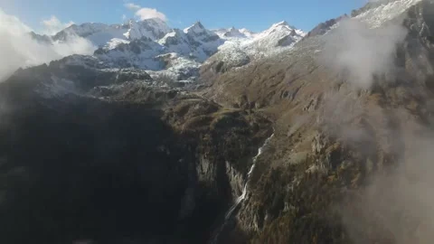 Drone flies through the clouds and the snowy mountains appear. Epic mountain Stock Footage 165826910