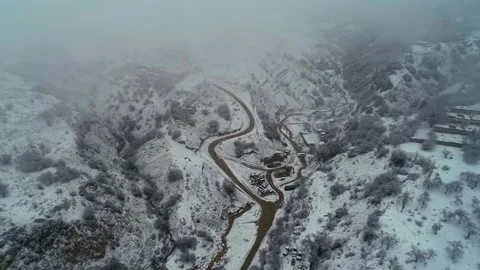 The drone flies through the clouds over the snow-covered mountains. Cloudy Stock Footage 278459289