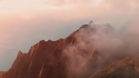 The drone flies through the haze over the golden slopes of the mountains Video stock 138237977