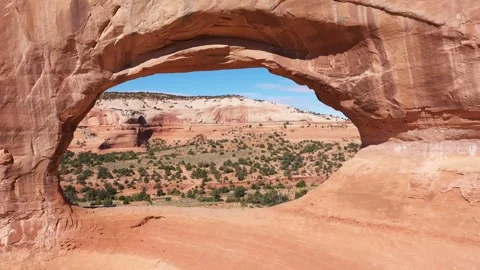 Drone Flies Through Red Orange Stone Arch With Massive Rock Formations In Utah Stock Footage 271033831
