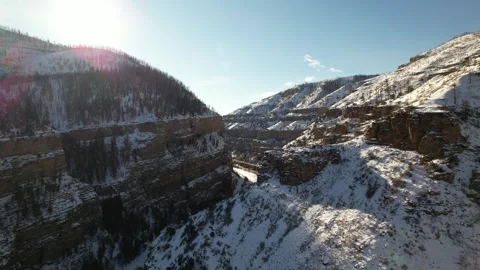 Drone Flies through Snow Covered Rocky Mountains in Glenwood Springs Colorado Stock Footage 296471650