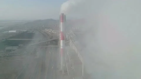 Drone flies through the thick smoke plumes. Aerial view of an industrial zone Video stock 153756147