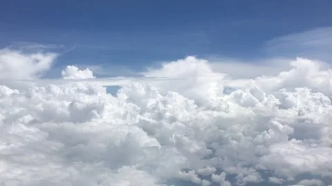 Drone flies through white clouds in blue sky Stock Footage 169774500