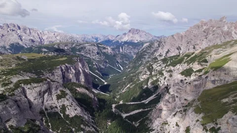 Drone flies toward a deep valley in the Dolomites near Misurina Stock Footage 346287981