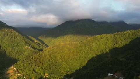 Drone flies toward sunlit mountains with cloud shadows, Adjara, Georgia 스톡 동영상 337336325