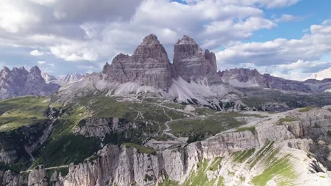 Drone flies in toward Tre Cime di Lavaredo and Rifugio Auronzo Stock Footage 346287993