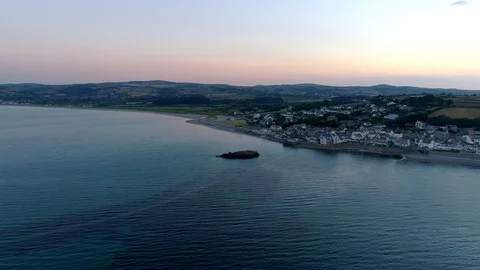 Drone flies towards Marazion in Cornwall at dawn Stock Footage 95123647