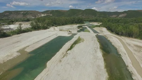 Drone flies towards over a dry river in France Stock Footage 145990649