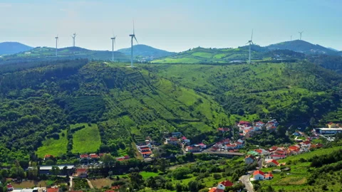 Drone flies towards the rotating blades of a wind turbines Stock Footage 265579164