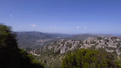 A drone flies trough a narrow opening and reveals a beautiful landscape Stock Footage 100816320