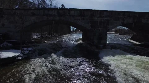 Drone flies under old stone bridge 4k Stock Footage 62944092